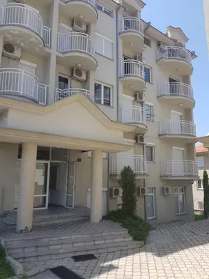 an apartment building with balconies and a courtyard at Kragić apartman in Soko Banja