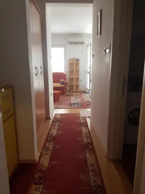 a hallway with a living room with a rug at Kragić apartman in Soko Banja