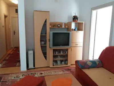 a living room with a tv on a entertainment center at Kragić apartman in Soko Banja