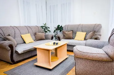 a living room with two couches and a coffee table at LOTUS (dvosoban apartman) in Vrnjačka Banja