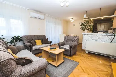 a living room with two couches and a coffee table at LOTUS (dvosoban apartman) in Vrnjačka Banja