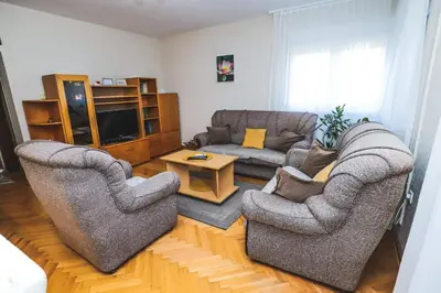 a living room with two chairs and a couch at LOTUS (dvosoban apartman) in Vrnjačka Banja