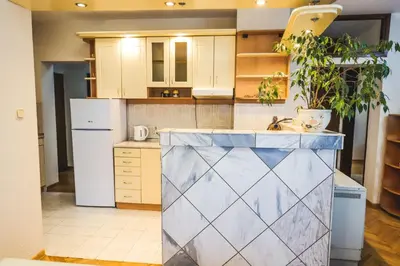 a kitchen with a sink and a white refrigerator at LOTUS (dvosoban apartman) in Vrnjačka Banja