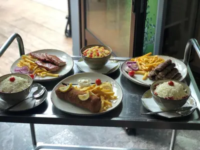 a table with plates of food and bowls of food at Sobe na Jošanici in Jošanička Banja