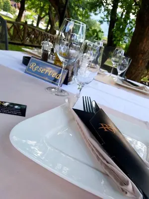 a white plate with a knife and fork on a table at Sobe na Jošanici in Jošanička Banja
