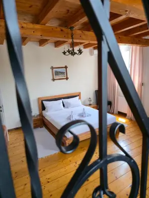 a bedroom with a bed and a wooden ceiling at Devedzic in Vrnjačka Banja