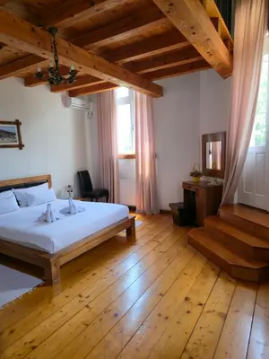 a bedroom with a bed and a wooden floor at Devedzic in Vrnjačka Banja