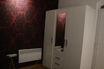 a white cabinet with a mirror in a room at Apartman ALEX LUX in Vrnjačka Banja