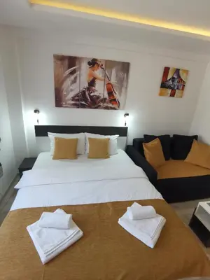 a bedroom with a large white bed and a couch at MILMARI STAR S71 LUX in Kopaonik