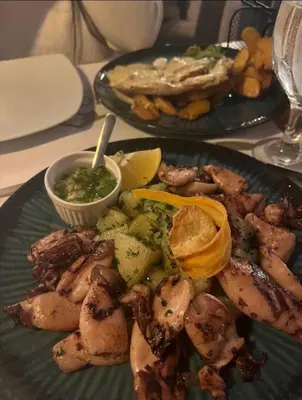 a plate of food with shrimp and vegetables on a table at MILMARI STAR S71 LUX in Kopaonik