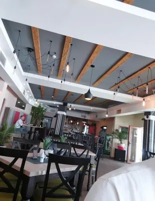 a restaurant with wooden ceilings and tables and chairs at MILMARI STAR S71 LUX in Kopaonik