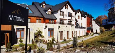 a large white building with a black roof at MILMARI STAR S71 LUX in Kopaonik
