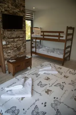 a bedroom with a bed with towels on it at Zoo Misic Prenoćište in Vranje