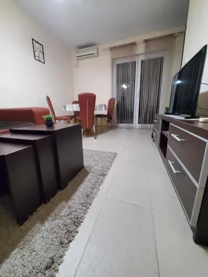 a living room with a couch and a television at Royal Panorama Apartman & 