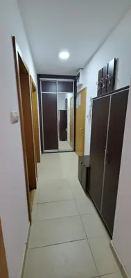 a hallway with doors and a tile floor at Royal Panorama Apartman & 