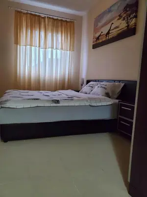 a bedroom with a large bed with a window at Royal Panorama Apartman & 
