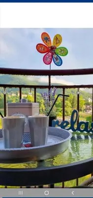 a table with two coffee cups and a butterfly sign at Royal Panorama Apartman & 