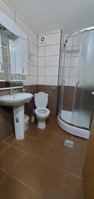 a bathroom with a toilet and a sink and a shower at Royal Panorama Apartman & 