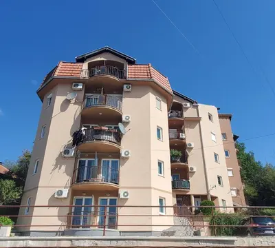 a tall building with balconies on the side of it at Royal Panorama Apartman & 
