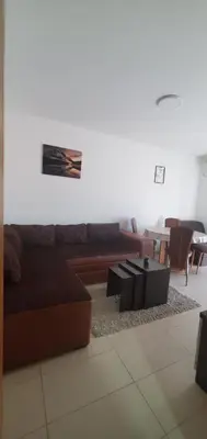 a living room with a couch and a table and chairs at Royal Panorama Apartman & 