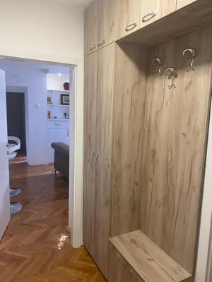 a bathroom with a wooden cabinet with a shower at Sandra in Niš
