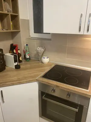 a kitchen with a stove and a counter top at Sandra in Niš