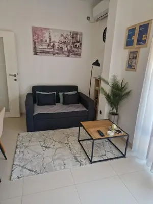 a living room with a couch and a coffee table at J&A Apartman in Jagodina