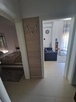 a room with a door leading to a bedroom at J&A Apartman in Jagodina