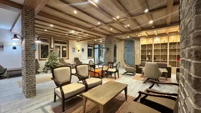 a lobby with chairs and tables and a christmas tree at Five-O-Six Apartment, Župa-Kopaonik in Kopaonik