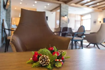 a christmas arrangement on a table in a restaurant at Five-O-Six Apartment, Župa-Kopaonik in Kopaonik