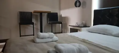 a bedroom with a bed with towels on it at Tajna037 in Kruševac