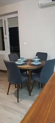a dining room table with chairs and a wooden table at Tajna037 in Kruševac