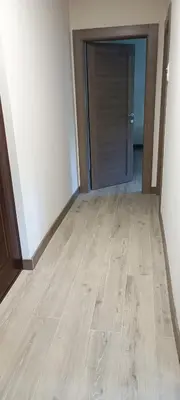 an empty room with a wooden floor and a door at Tajna037 in Kruševac