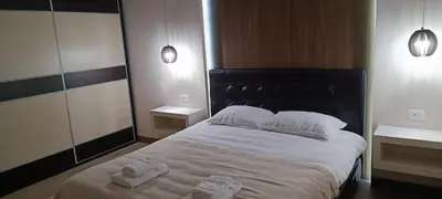 a bedroom with a large bed with towels on it at Tajna037 in Kruševac