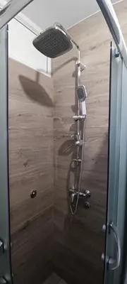 a shower with a shower head in a bathroom at Tajna037 in Kruševac