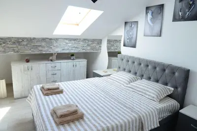 a bedroom with a bed with two towels on it at Studio Apartman Dunja in Jagodina