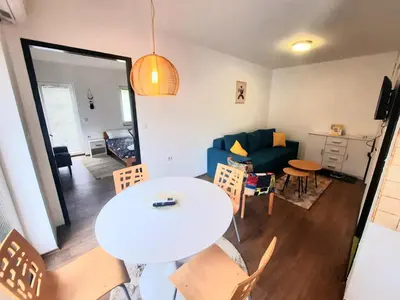 a living room with a table and a couch at Apartman Vista in Soko Banja