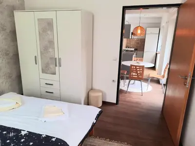 a small room with a bed and a dining room at Apartman Vista in Soko Banja