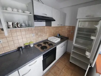 a kitchen with a stove and a refrigerator at Apartman Vista in Soko Banja