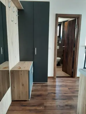 a hallway with wood flooring and a door to a bathroom at Vihor A21 in Kopaonik