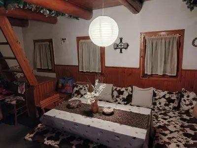 a living room with a couch and a chandelier at Vila Lara in Kopaonik