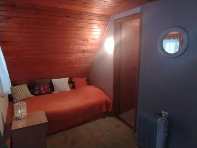 a bedroom with a bed in a wooden room at Vila Lara in Kopaonik