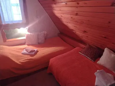 a room with two beds and a window in a room at Vila Lara in Kopaonik