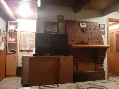 a living room with a tv on top of a table at Vila Lara in Kopaonik