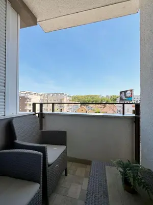 a balcony with chairs and a view of a city at Apartman Elena 11 in Vrnjci