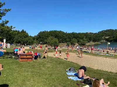 a group of people on the beach at a park at Apartmani Plaža in Bor