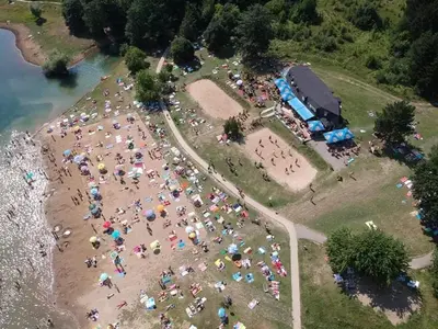 an aerial view of a crowd of people on a beach at Apartmani Plaža in Bor