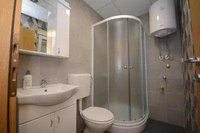 a bathroom with a shower and a toilet and a sink at Apartman Jocić in Vrnjačka Banja