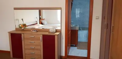 a bathroom with a sink and a large mirror at Apartmani Filipi in Vrnjačka Banja