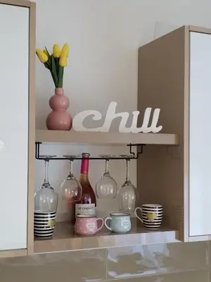 a shelf with a bunch of glass bottles and cups at Apartman Ljubičica in Vrnjačka Banja
